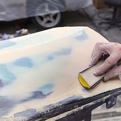 Sanding the paint off the plastic parts with sandpaper Sanding the paint off the plastic parts with sandpaper