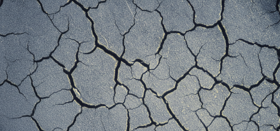 Magnified cross section of a steel surface exhibiting severe heat checking and deep fissures