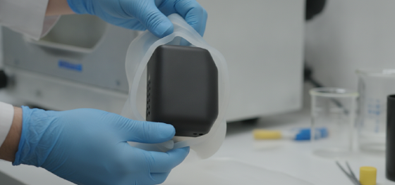Technician peeling a silicone mold revealing a perfectly cured polyurethane electronic enclosure